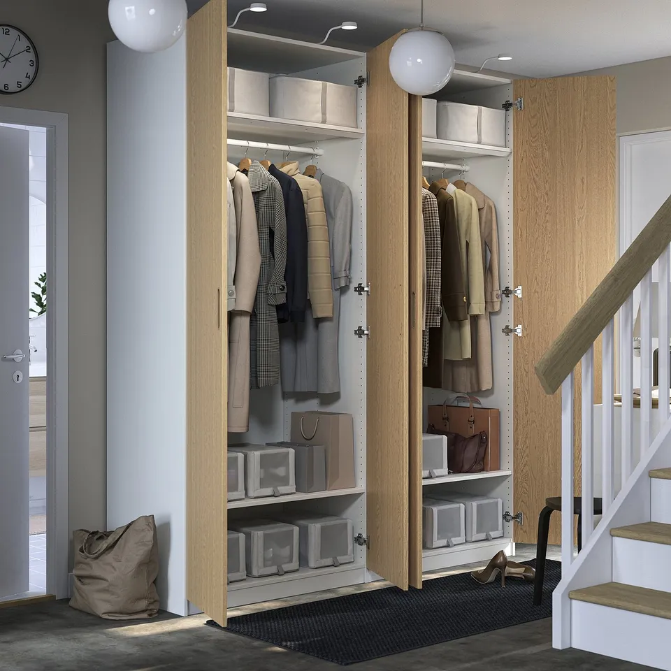 Modern closet with coats, shelves, and lighting.