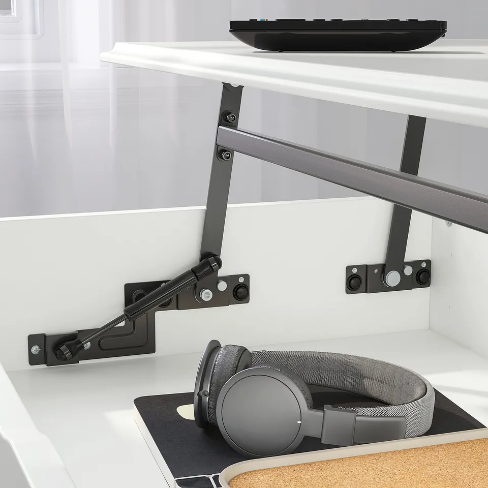 Desk with adjustable arm holding keyboard and headphones below.