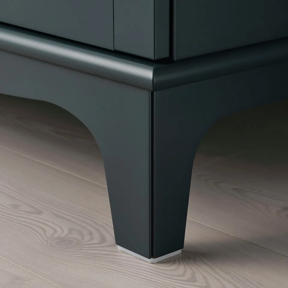 Green wooden cabinet with curved legs on floor.