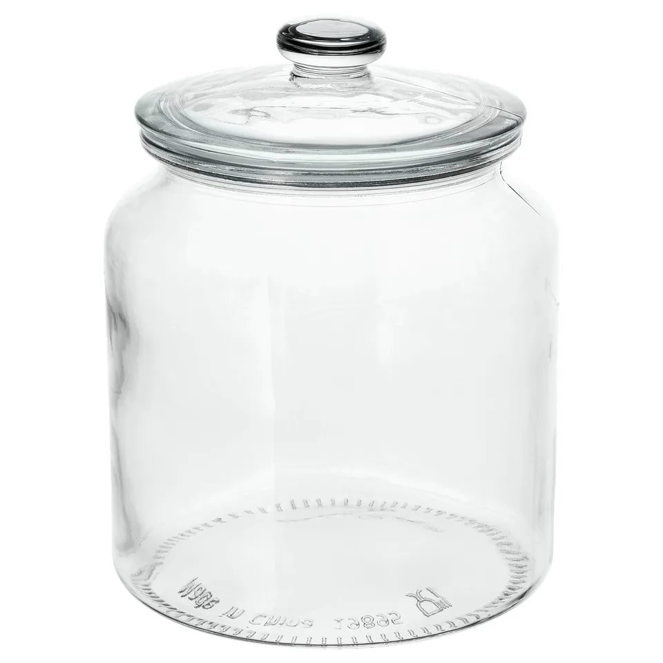This image a VARDAGEN clear glass storage jar with a metal-trimmed lid. Ideal for storing items like muesli, its transparent design contents easily.