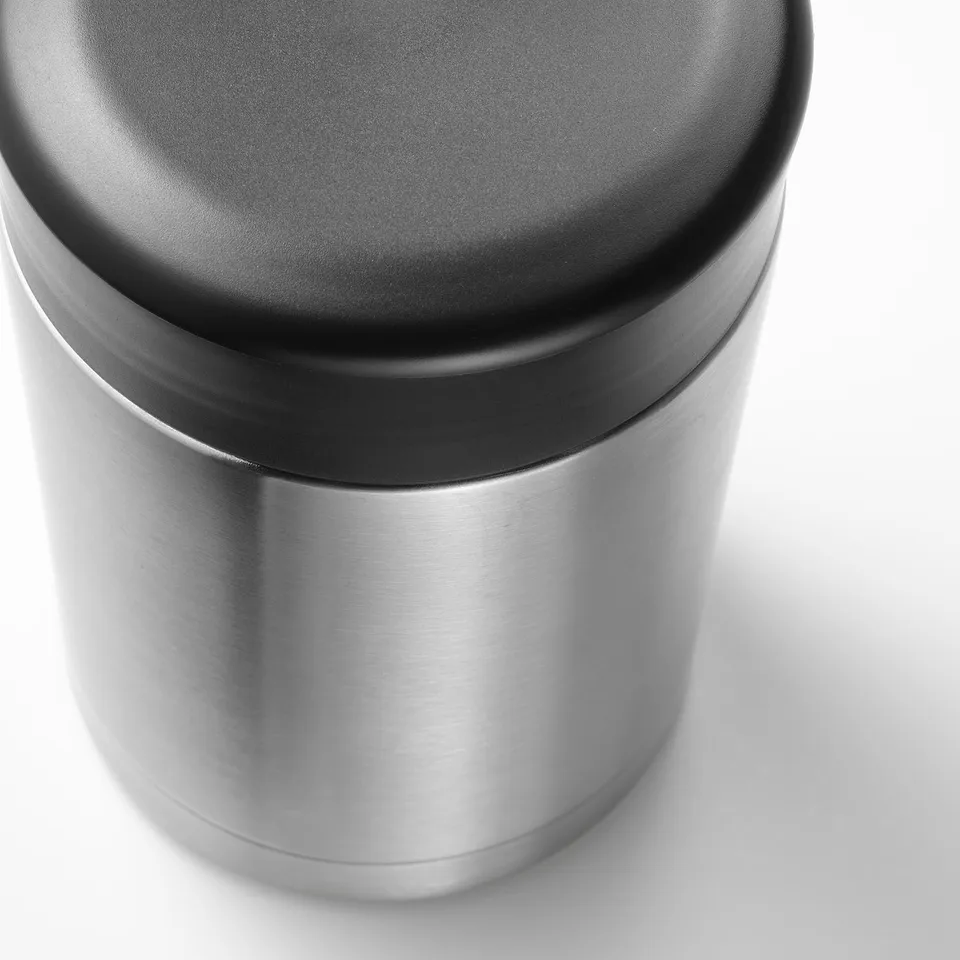Stainless steel food flask with secure black lid, smooth finish, sleek design.