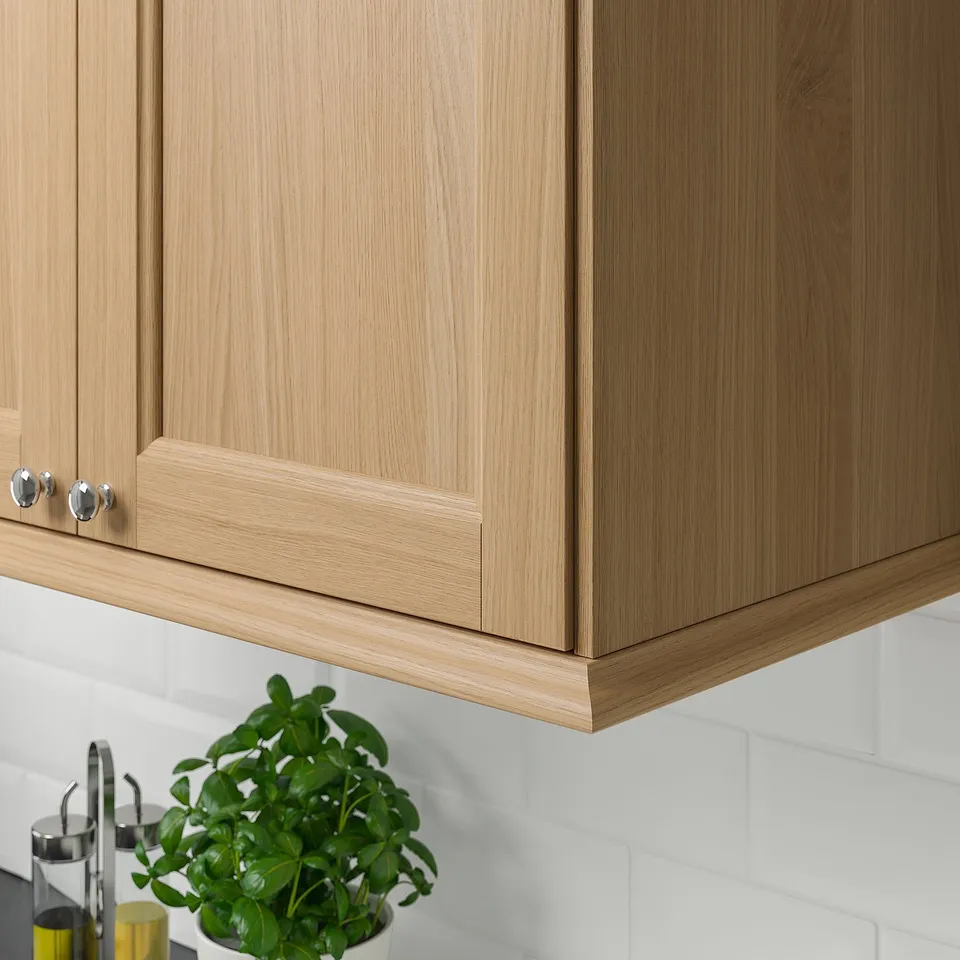 Oak cabinet with chrome handles and lighting.
