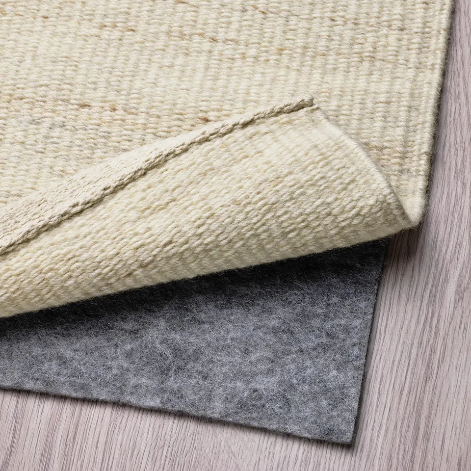 Rug with anti-slip underlay for safety and comfort.