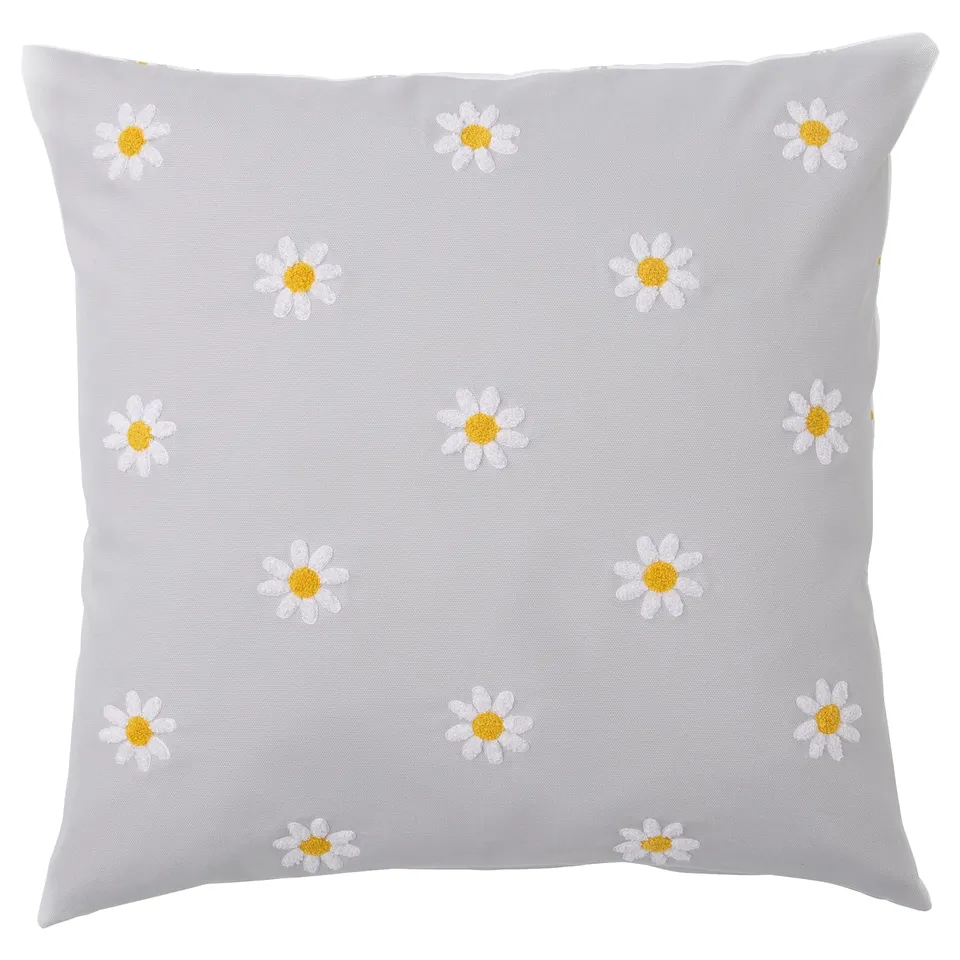 NATTSLÄNDA grey square cushion with white daisy tufts.