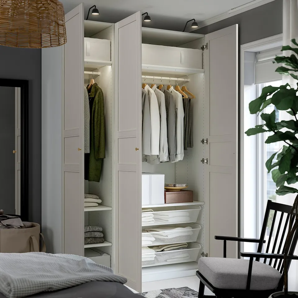 Well-organized wardrobe with hanging clothes and shelves, featuring integrated lighting and adjustable storage.