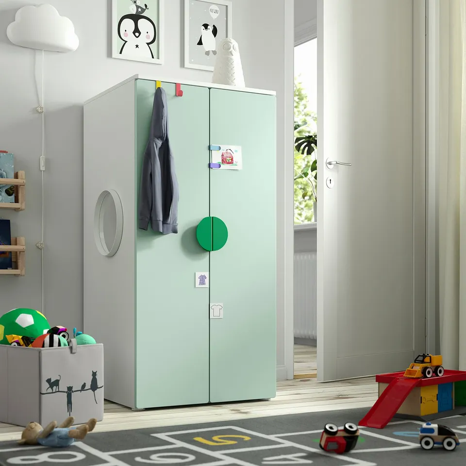 Kids room with green SMÅSTAD wardrobe, toys, and playful decor.