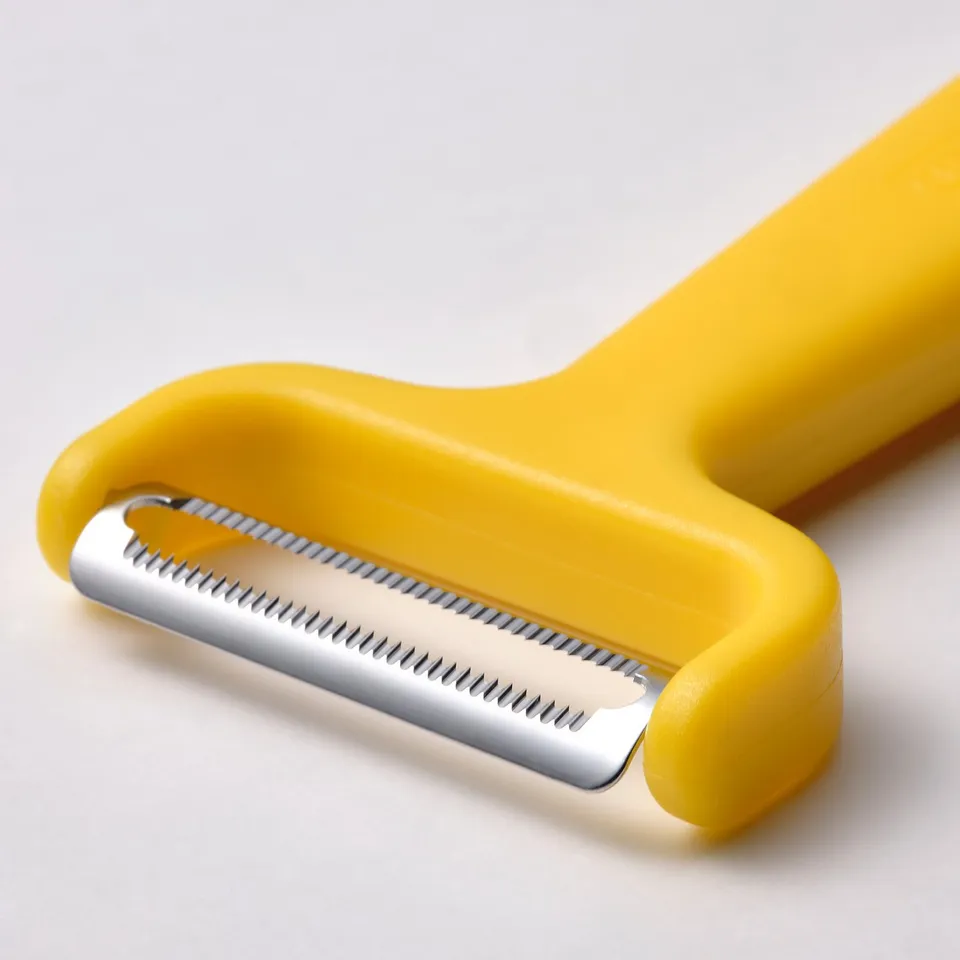 Bright yellow UPPFYLLD vegetable peeler with sharp stainless steel blade and ergonomic handle.