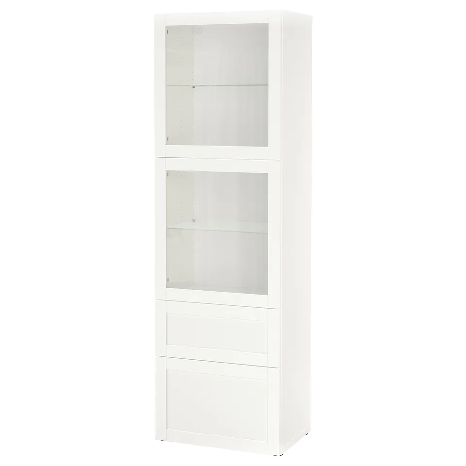 A white BESTÅ cabinet with glass doors, offering storage and display. It has three sections, including two drawers and adjustable shelves.