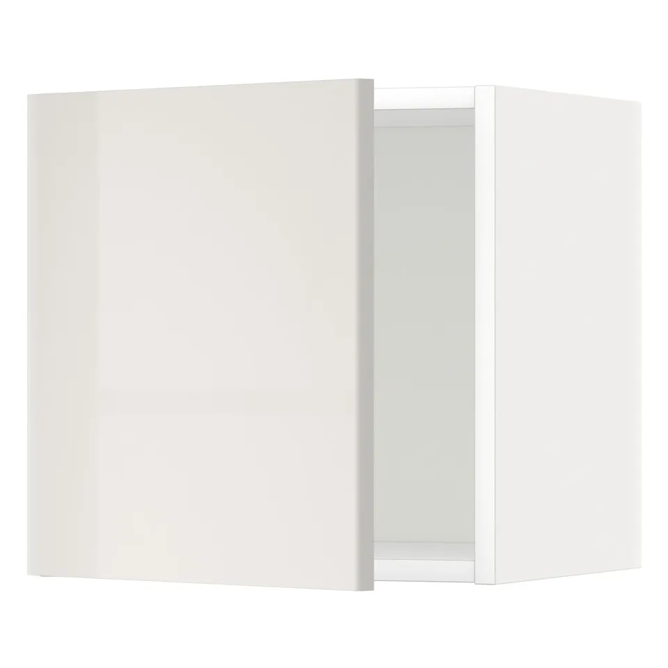Modern, glossy white wall cabinet, slightly ajar in kitchen.