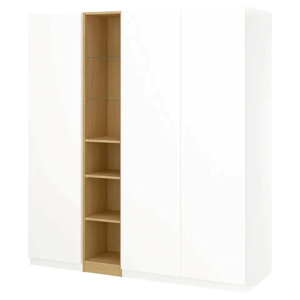 White PAX wardrobe with tall wooden shelf unit, featuring glass shelves and soft-close hinges.