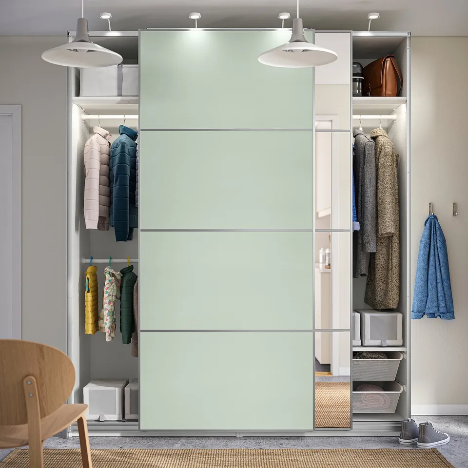 Modern wardrobe with sliding doors, hanging clothes, shelves, and overhead storage. Soft-close mechanism and adjustable feet for floor irregularities.