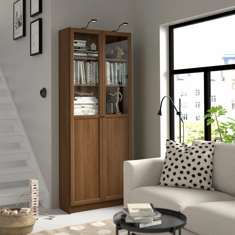 Stylish living room with BILLY bookcase, armchair, and natural light.