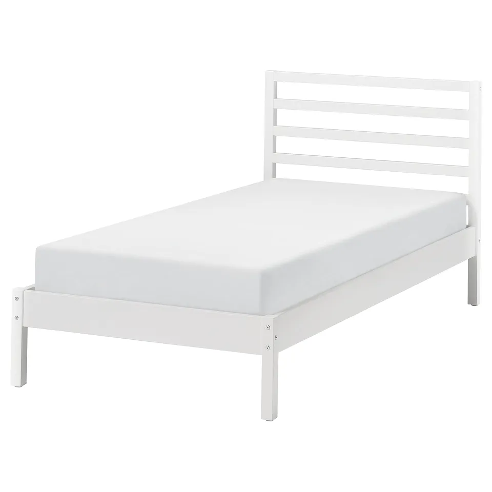 A TARVA white twin bed frame with wooden slats and headboard. Clean and simple, its made of stained pine wood.