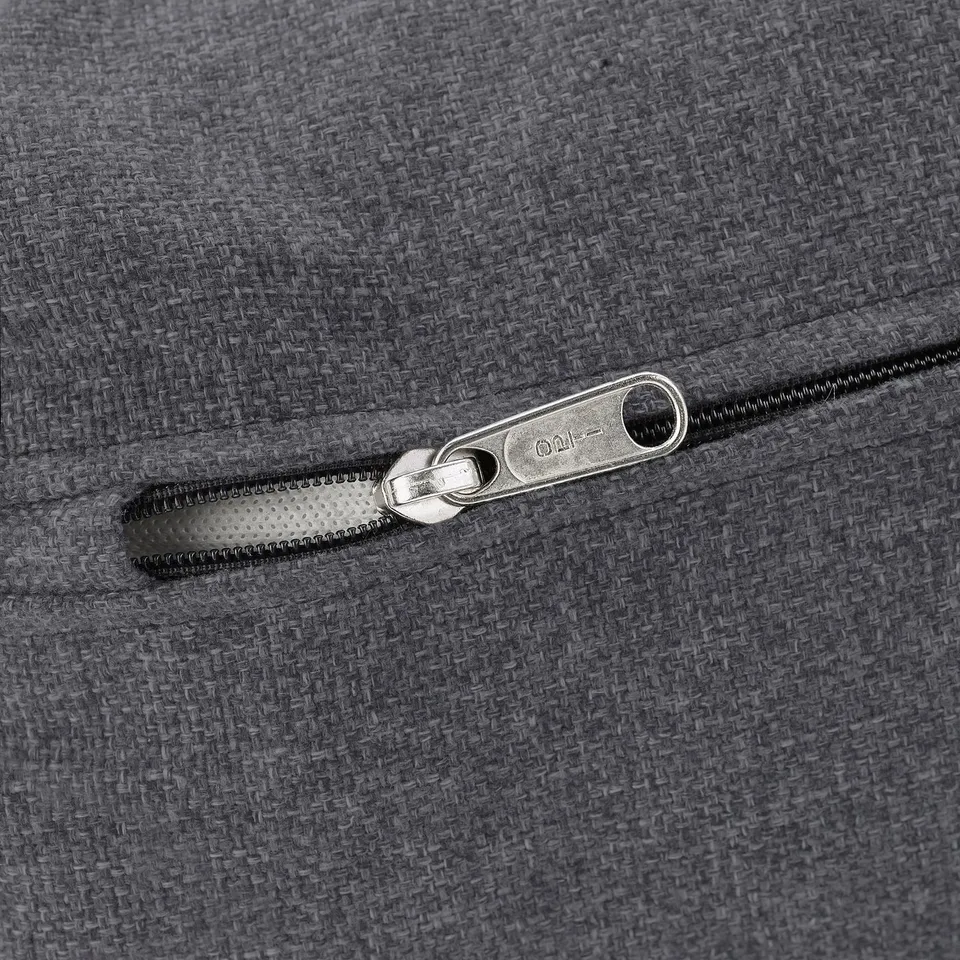 Image shows a high-quality zip on a grey fabric item, highlighting its smooth gliding mechanism and durable construction.