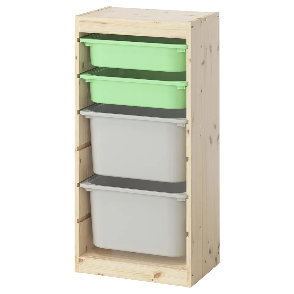 An ikea TROFAST wooden storage unit with green and white plastic boxes, ideal for organizing childrens toys.