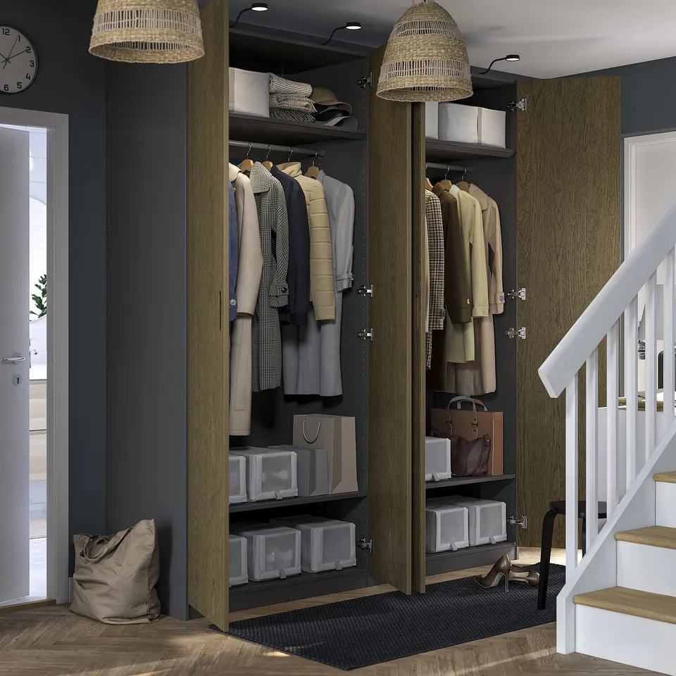 Modern walk-in closet with lit clothes and accessories, featuring adjustable shelves and hanging space.