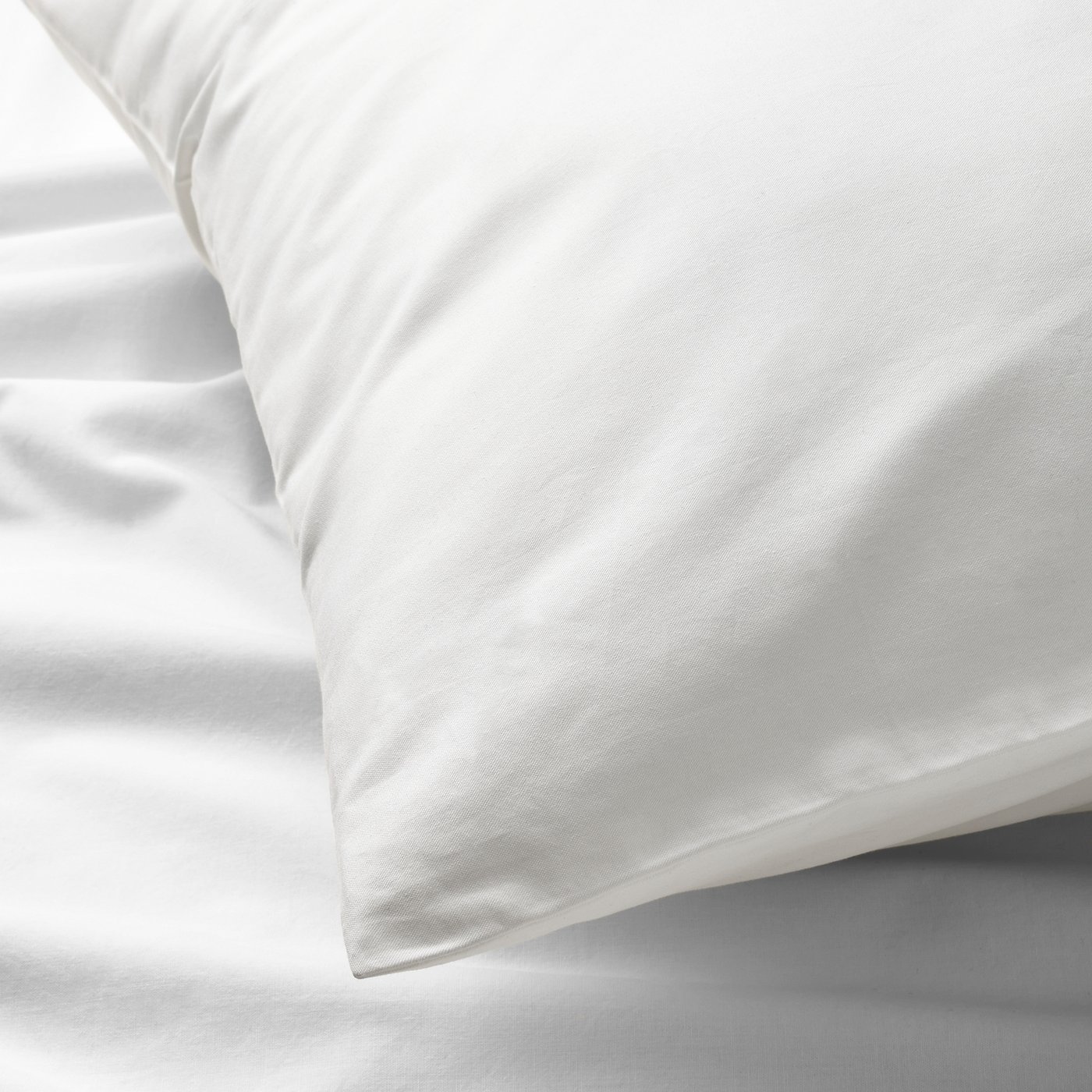 Crisp, cool white cotton percale sheets & pillowcases, featuring smooth, even texture & subtle sheen, neatly arranged.