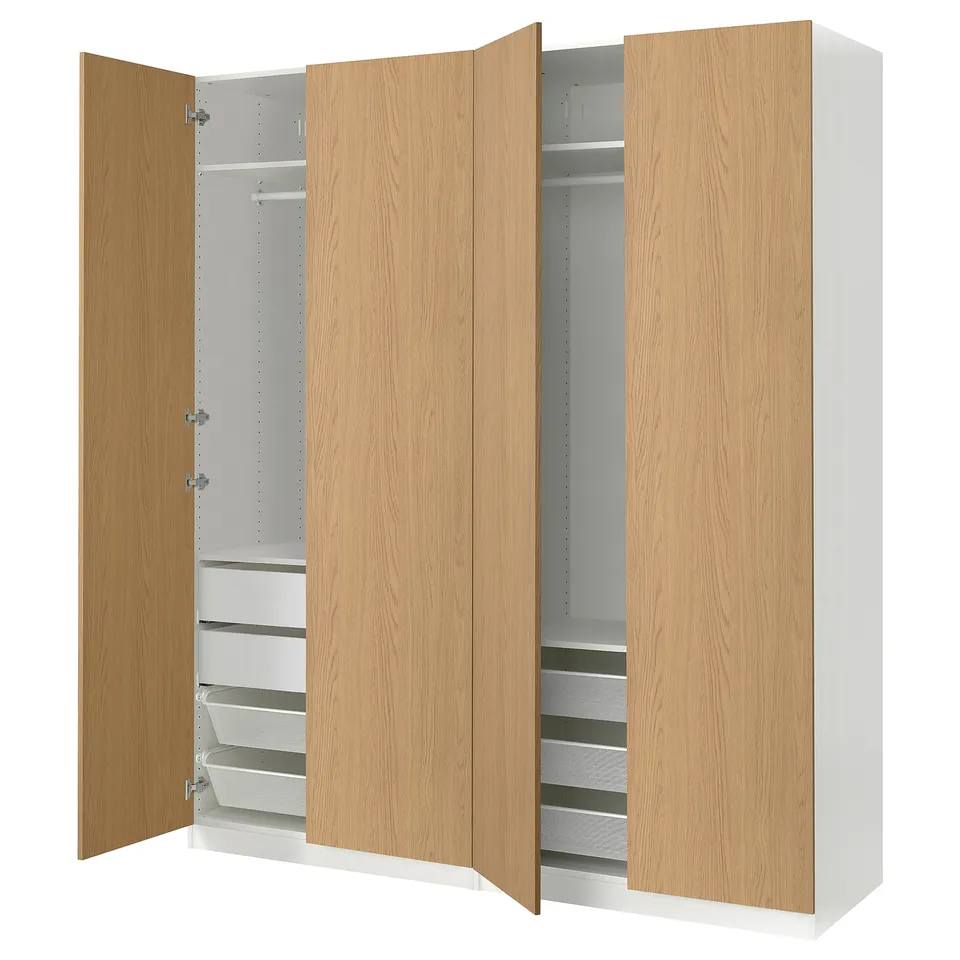 An ikea PAX wardrobe with light oak veneer doors and a white frame. It has adjustable shelves and drawers for versatile storage.