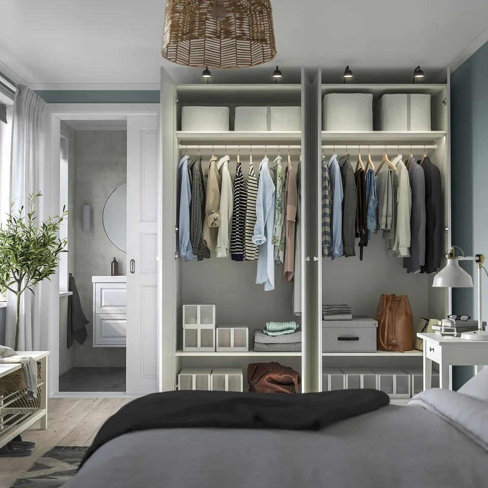 Bedroom with large open wardrobe displaying clothes, accessories, and organised storage. Wardrobe has adjustable shelves and integrated lighting.
