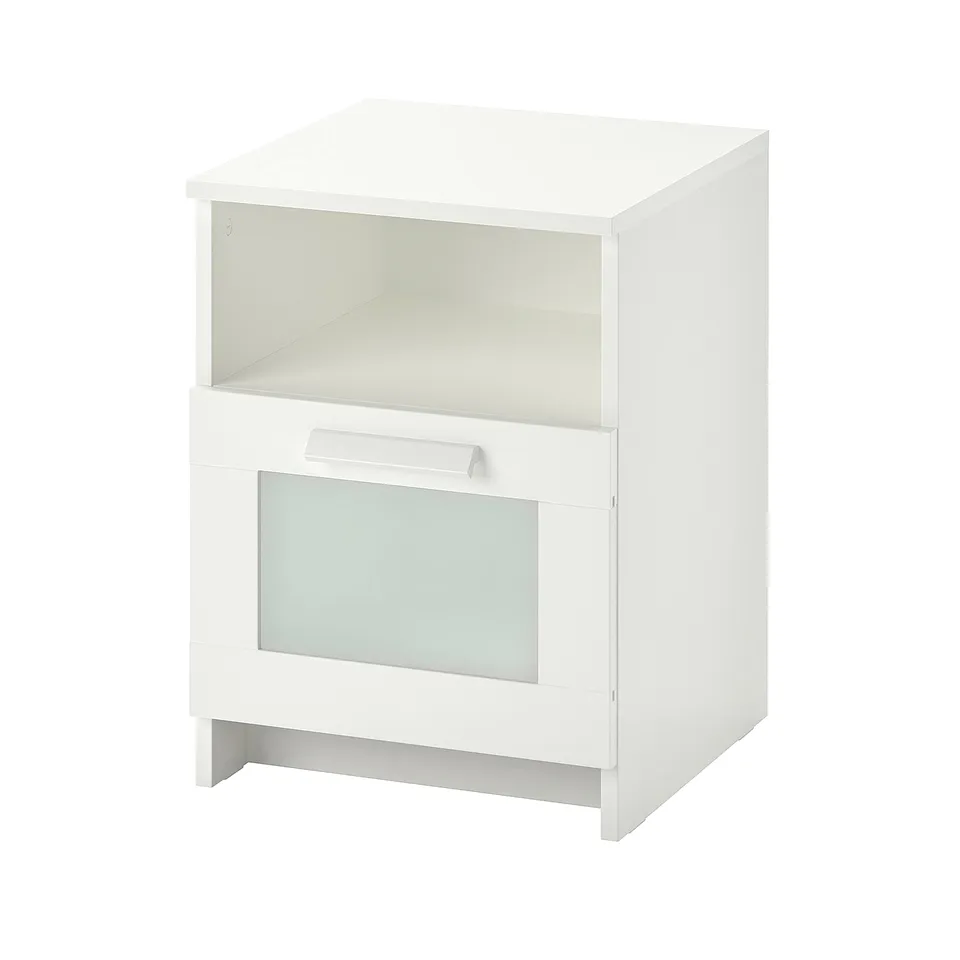 A white BRIMNES bedside table with glass-front drawer and metal handle.