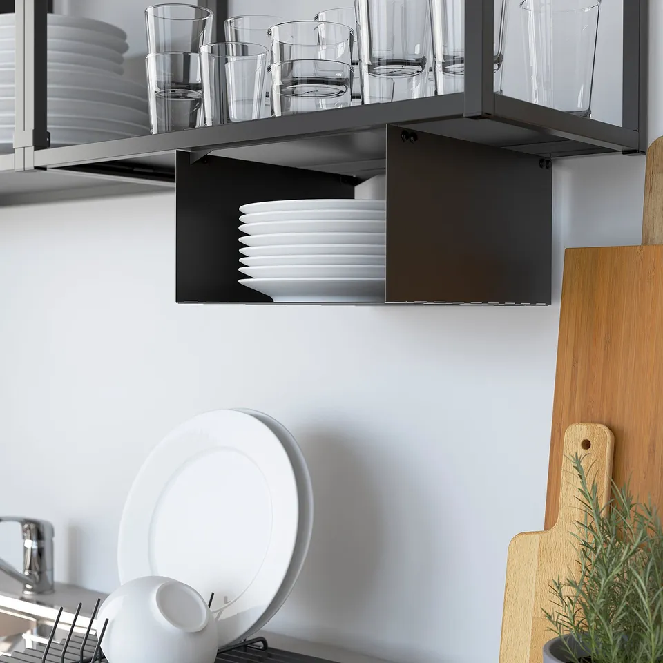 Kitchen shelf displays glasses and plates neatly, with additional storage below.
