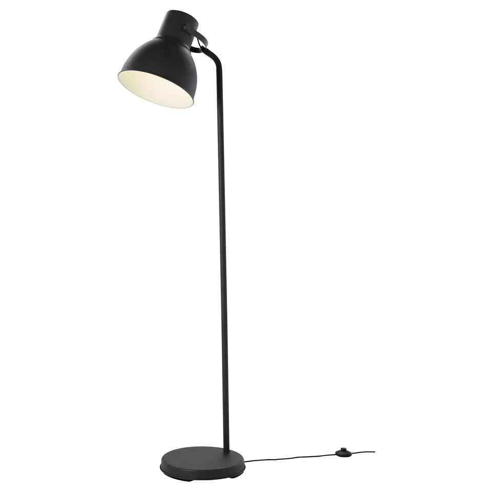 A black HEKTAR floor lamp with a large, adjustable metal shade, standing on a round base.