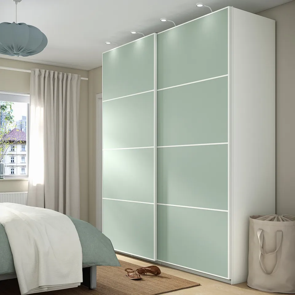Green PAX wardrobe with soft-close, multiple compartments, near ceiling height, sleek modern sliding door.