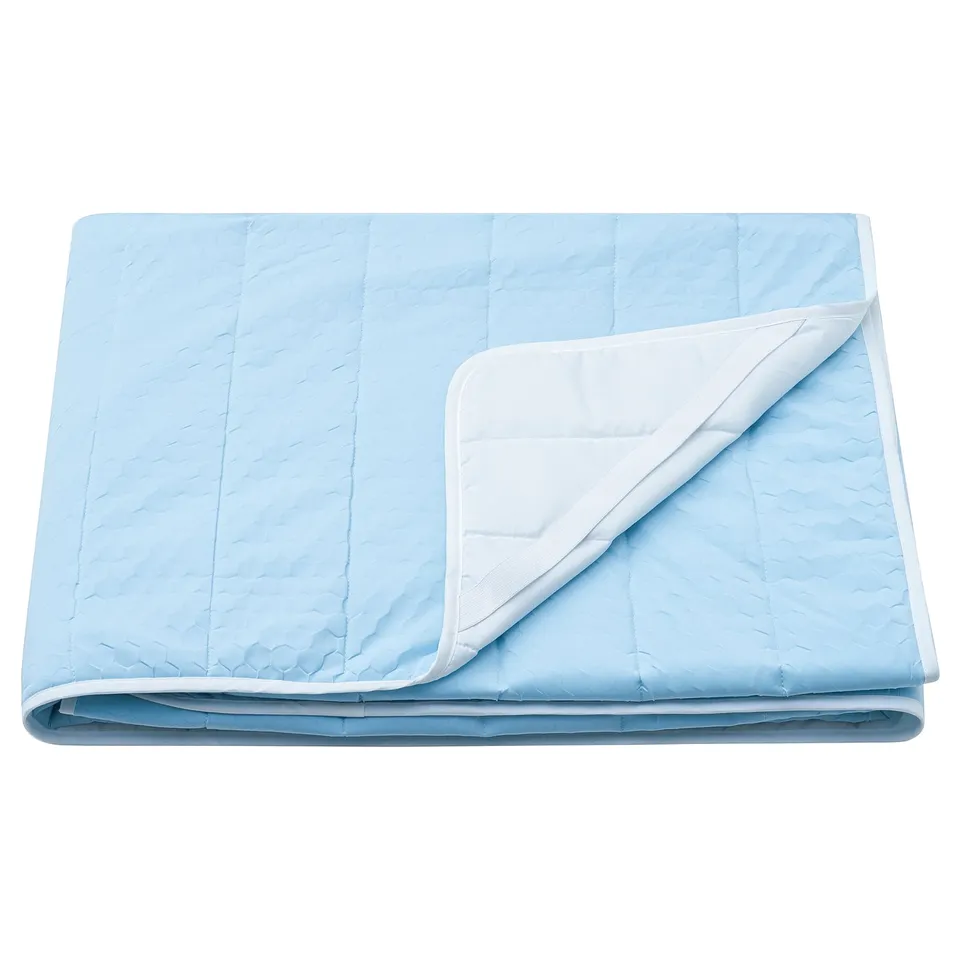 Blue mattress protector with white fold detail, soft quilted design.