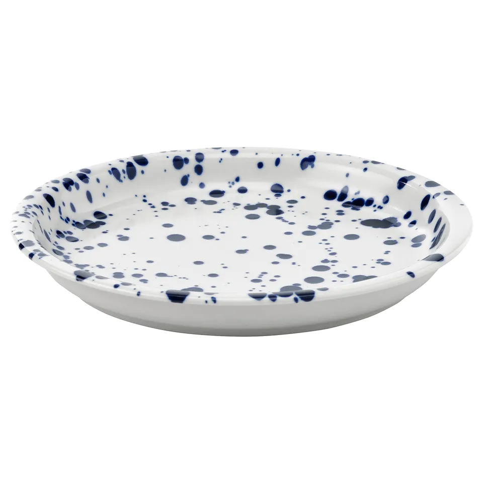 Round white plate with blue splatter design.