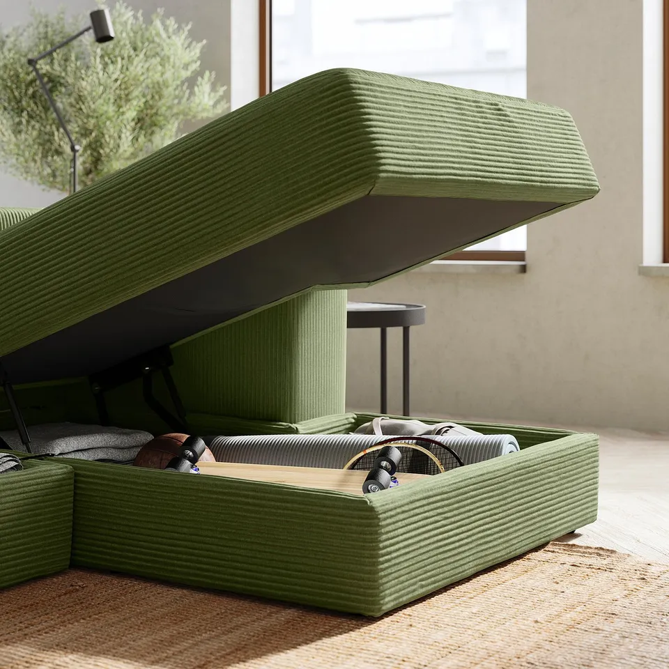 Green JÄTTEBO sofa, modern design, with storage for cushions and blankets.