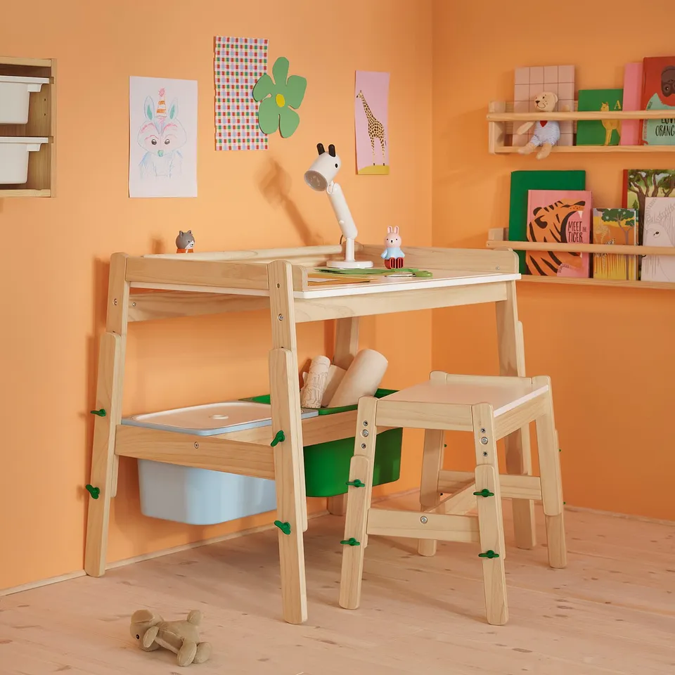 A wooden kids bench with two storage bins, adjustable height, perfect for sitting and playing, crafting, or reading.