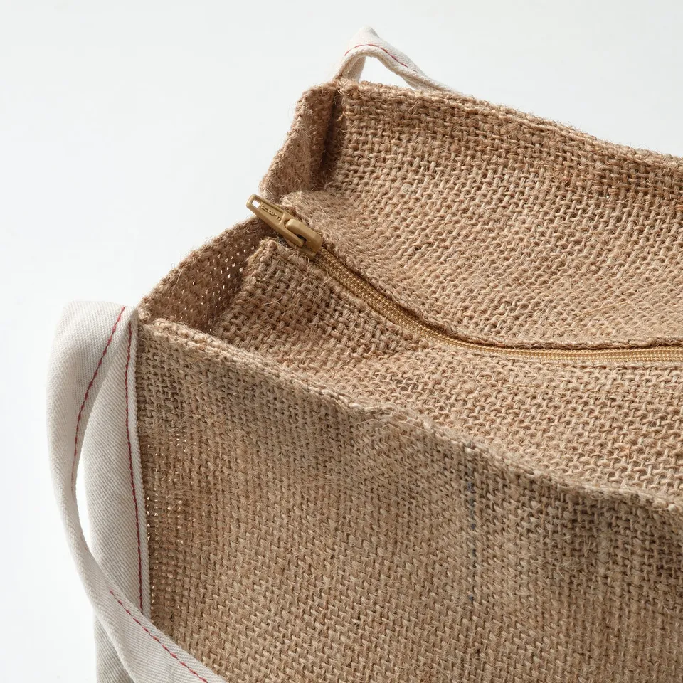 Close-up of durable jute storage bag with sturdy zip and handles, showcasing its high-quality craftsmanship.