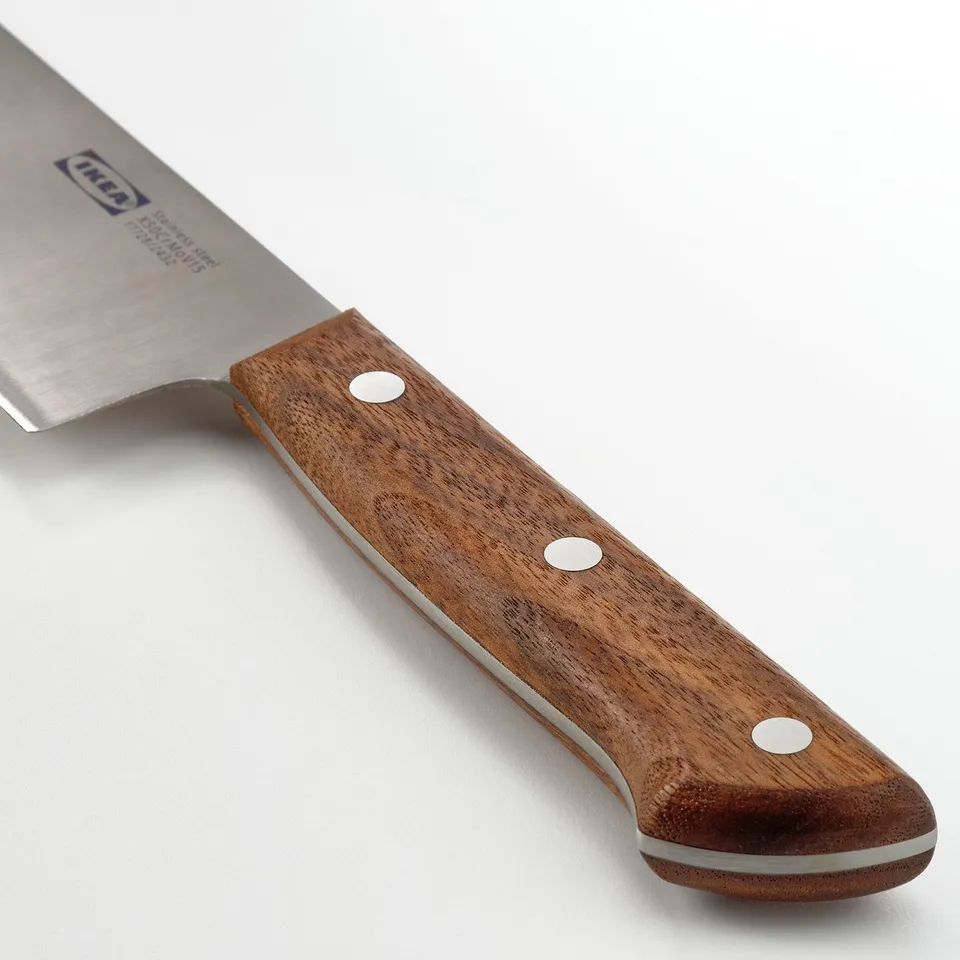 Close-up of a high-quality knife with a walnut handle and stainless steel blade.