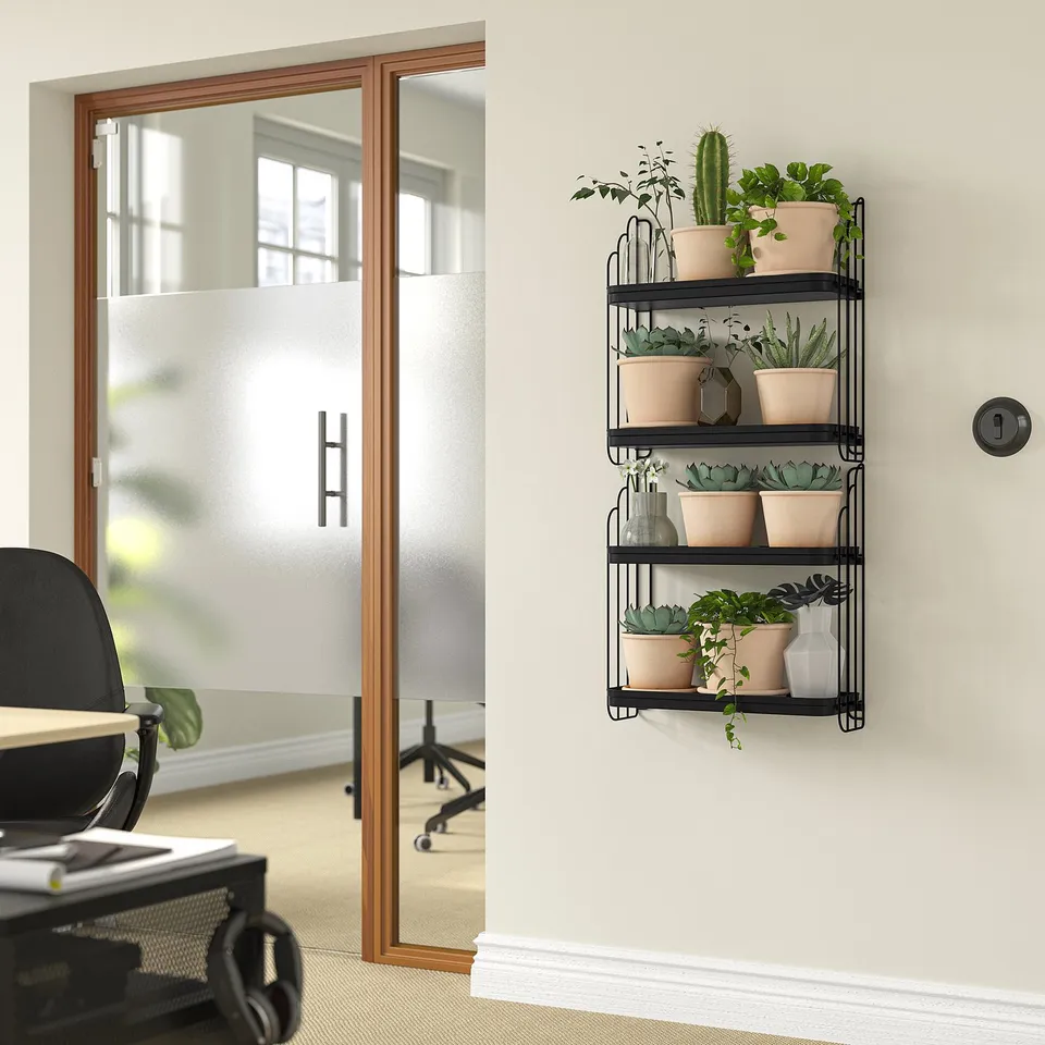 APOTEKARE shelf with plants under window beside chair.