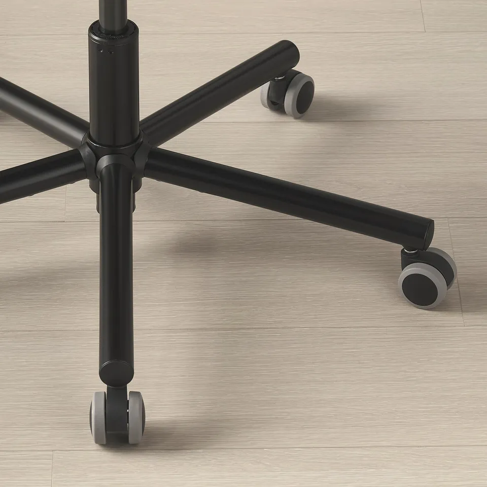 Chair base with sturdy metal frame and smooth wheels on wooden floor.