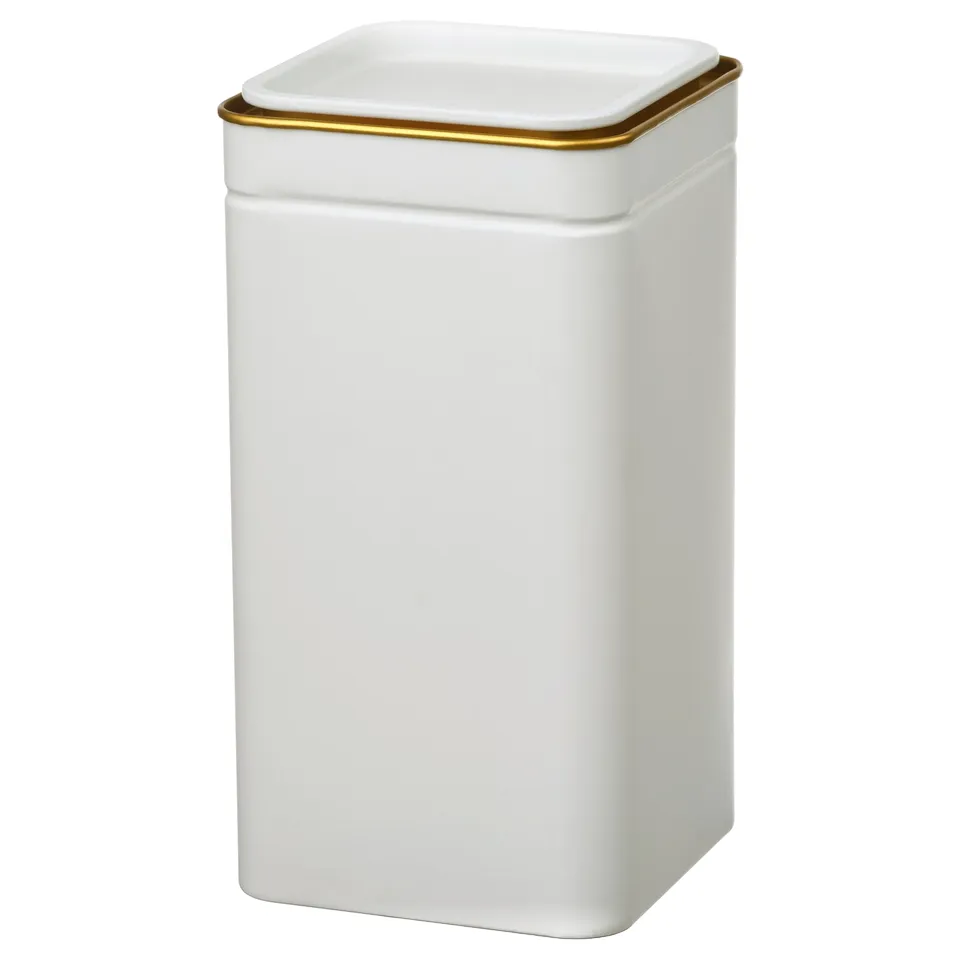 A white BLOMNING container with a gold rim, made of tinplated steel, in a rectangular shape.