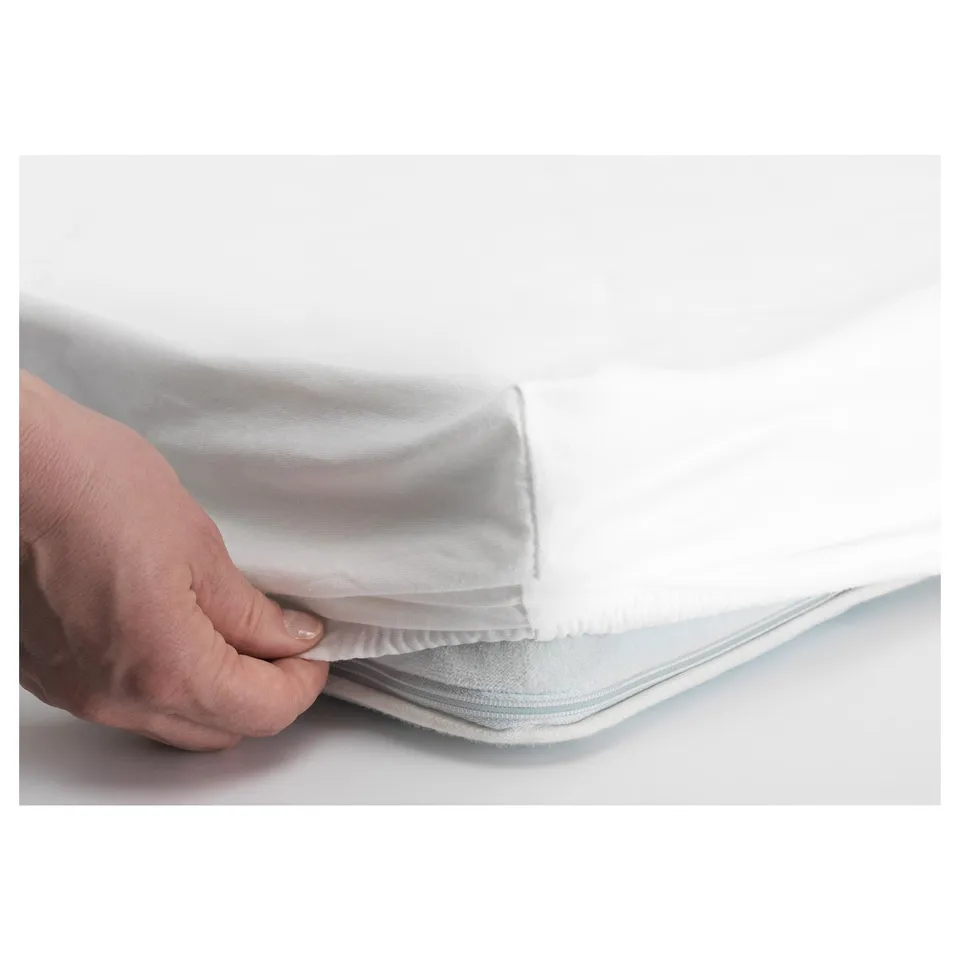 Hand tucks fitted sheet, elastic keeps it secure.