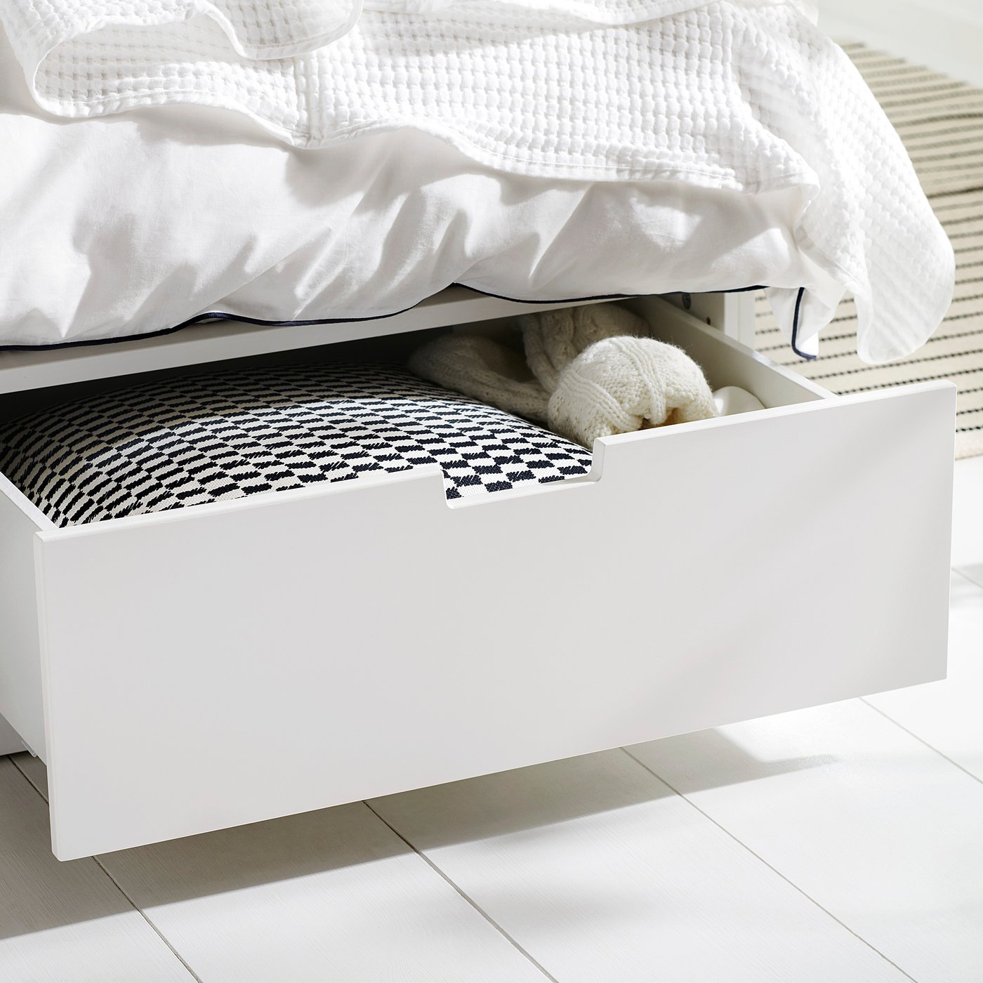 Under-bed drawer, white, stores textiles, sleek.