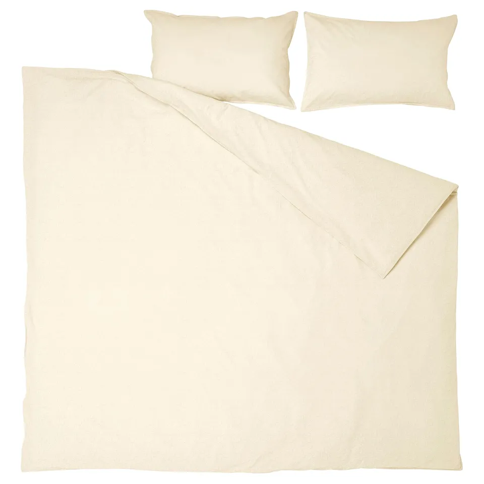 The ÄNGSLILJA beige bedding set in natural cotton. It includes a duvet cover and two pillowcases, displayed neatly with minimalist design.