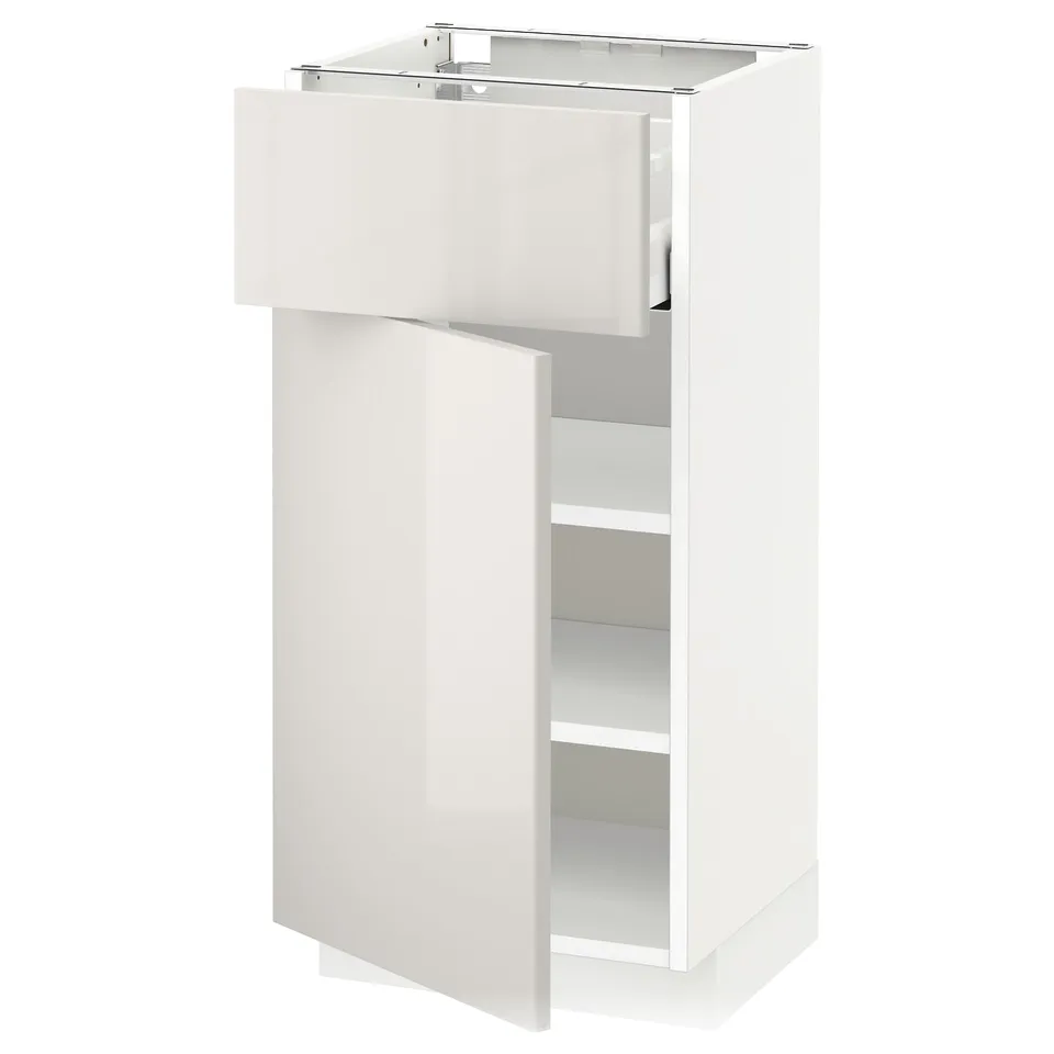 White glossy kitchen cabinet with wide drawer and shelf, sleek modern design.