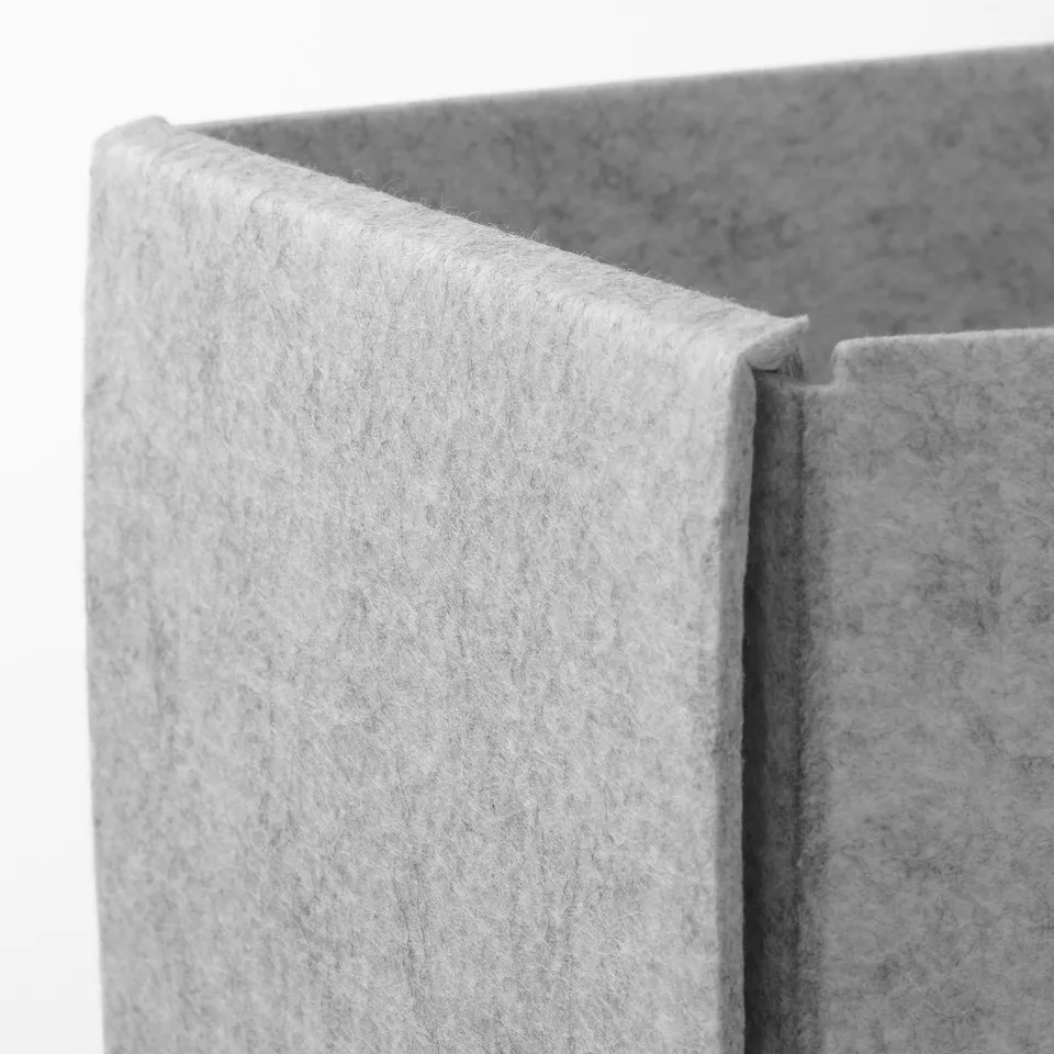Closeup of grey fabric box edge, showcasing soft texture and seamless join.