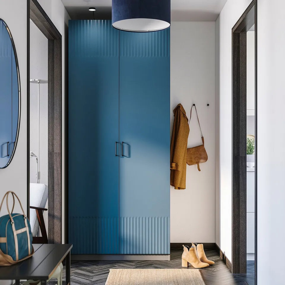 Deep blue PAX wardrobe with yellow coat, brown bag, and beige boots. Modern, sleek design.