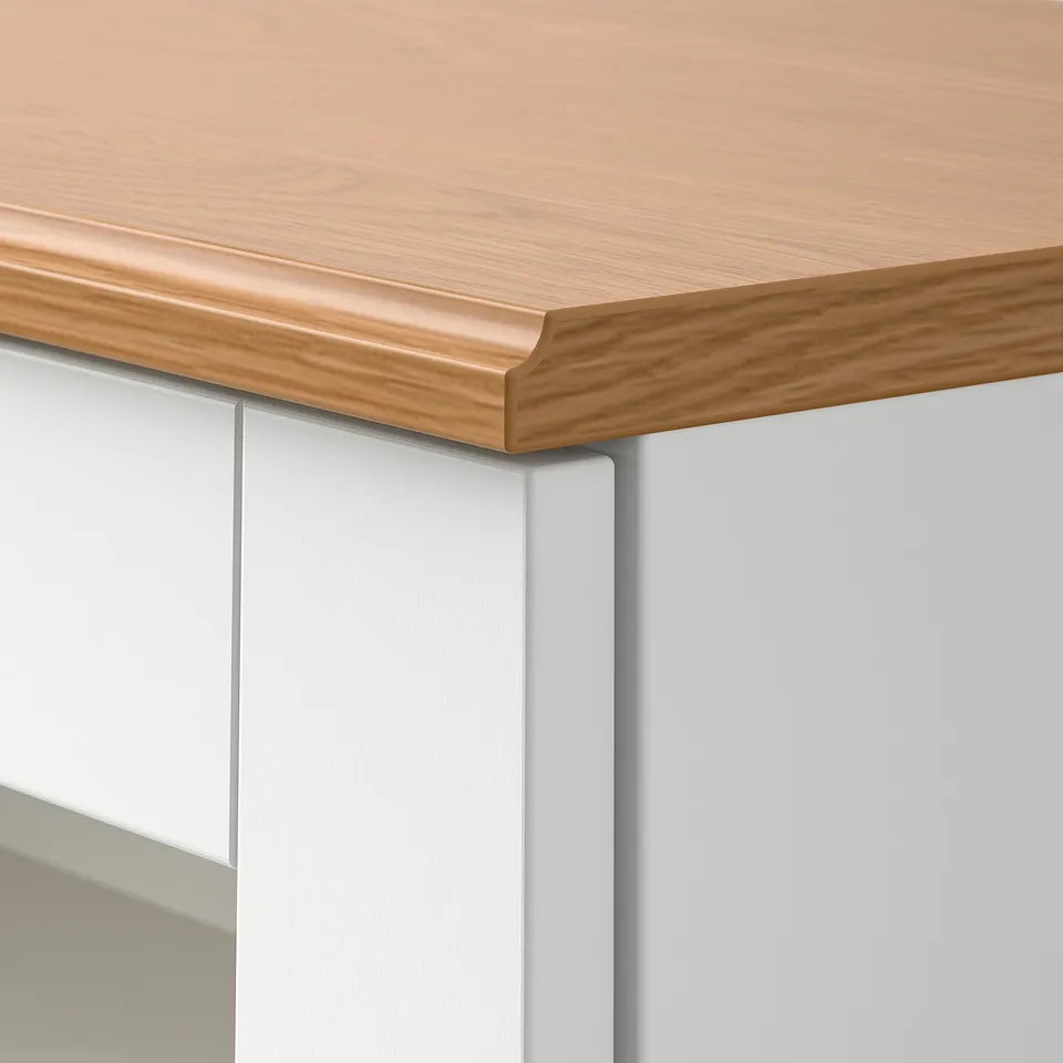 Close-up of SKRUVBY furniture edge: light wood top, smooth finish, sleek design.