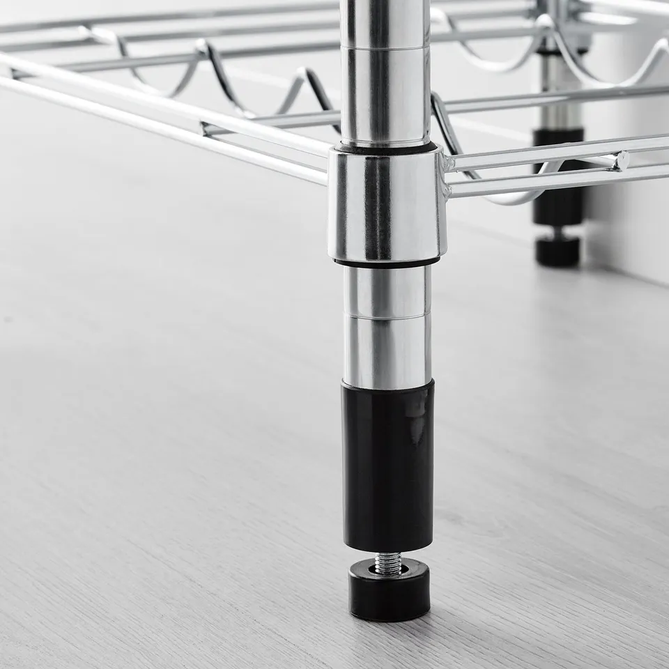 Adjustable shelf leg close-up; chrome-plated, black feet, secured to wood floor.