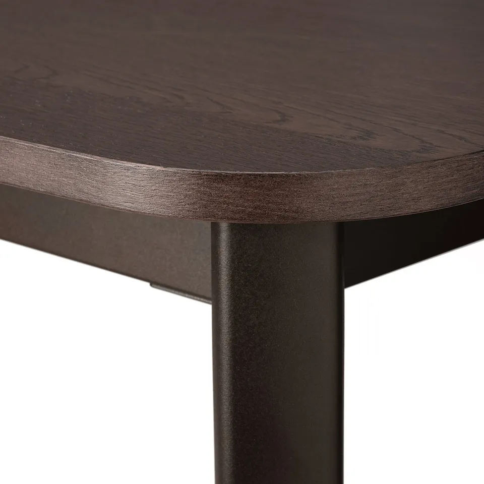 Close-up of STRANDTORP tables dark wood top and durable metal leg.