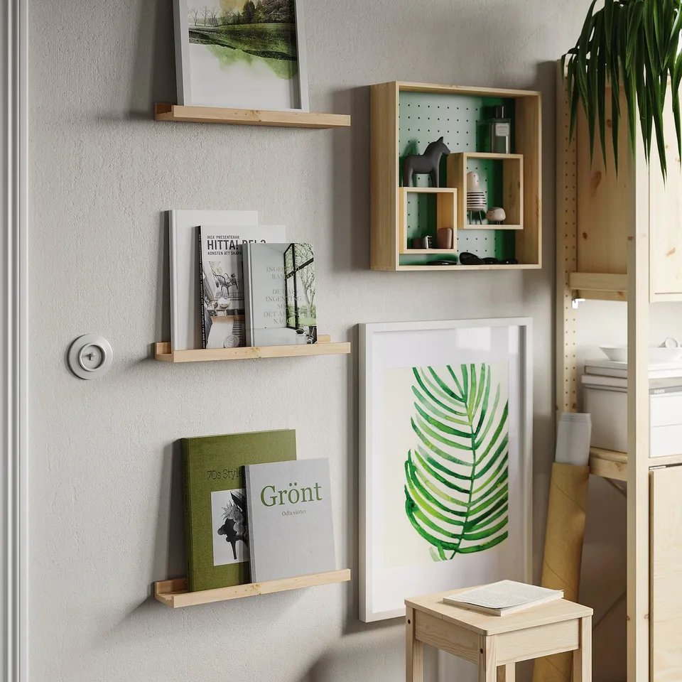 NORDHÄGG pine shelf holds books, adorned with art. Compact yet stylish, it blends seamlessly with decor.
