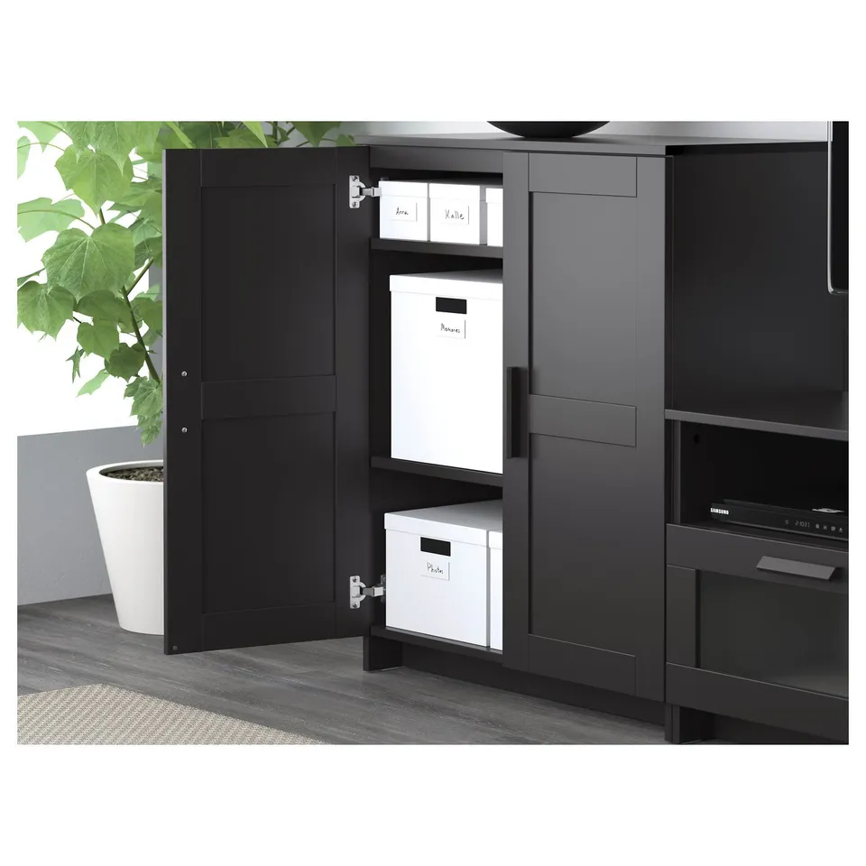 Black tv unit with open doors revealing storage boxes and shelves, designed to organise media and cables.
