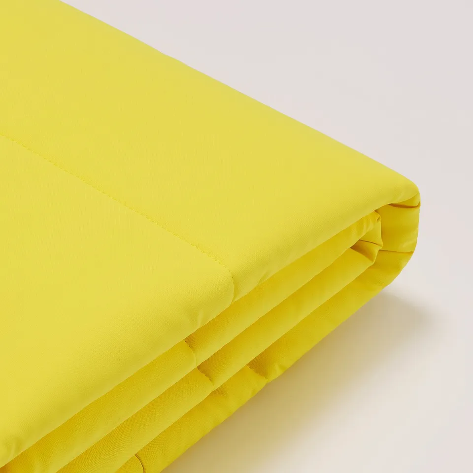 Bright yellow fabric, tightly folded with neat, even stitching. Soft texture, high-quality craftsmanship evident.
