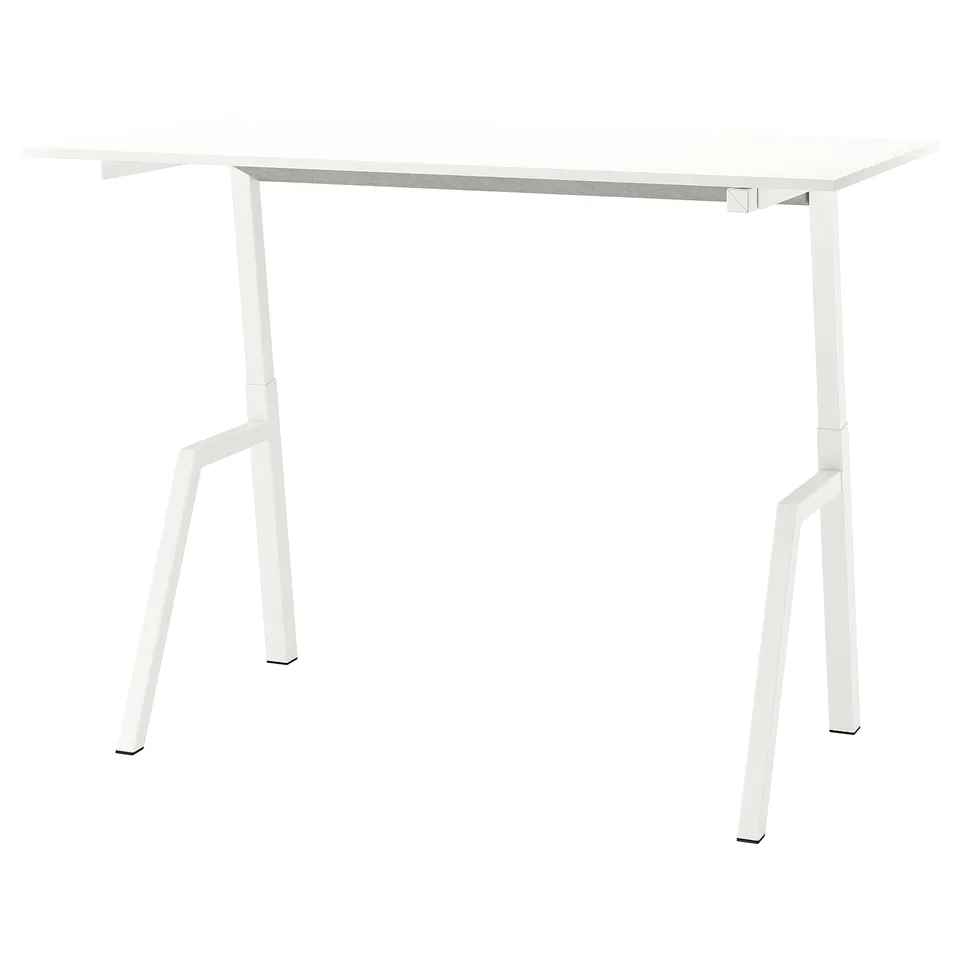 A white trottem sit-stand table. It has a rectangular top and four angled legs.