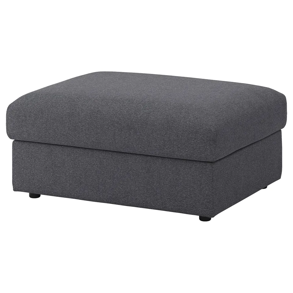 A grey VIMLE footstool with storage. Its rectangular, covered in speckled fabric, and sits on black rounded legs.